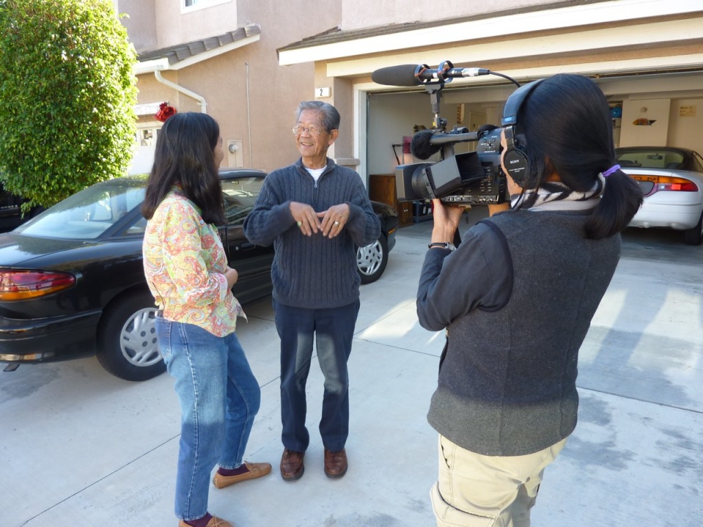 Photo of Robin Lung talking to Andrew Li