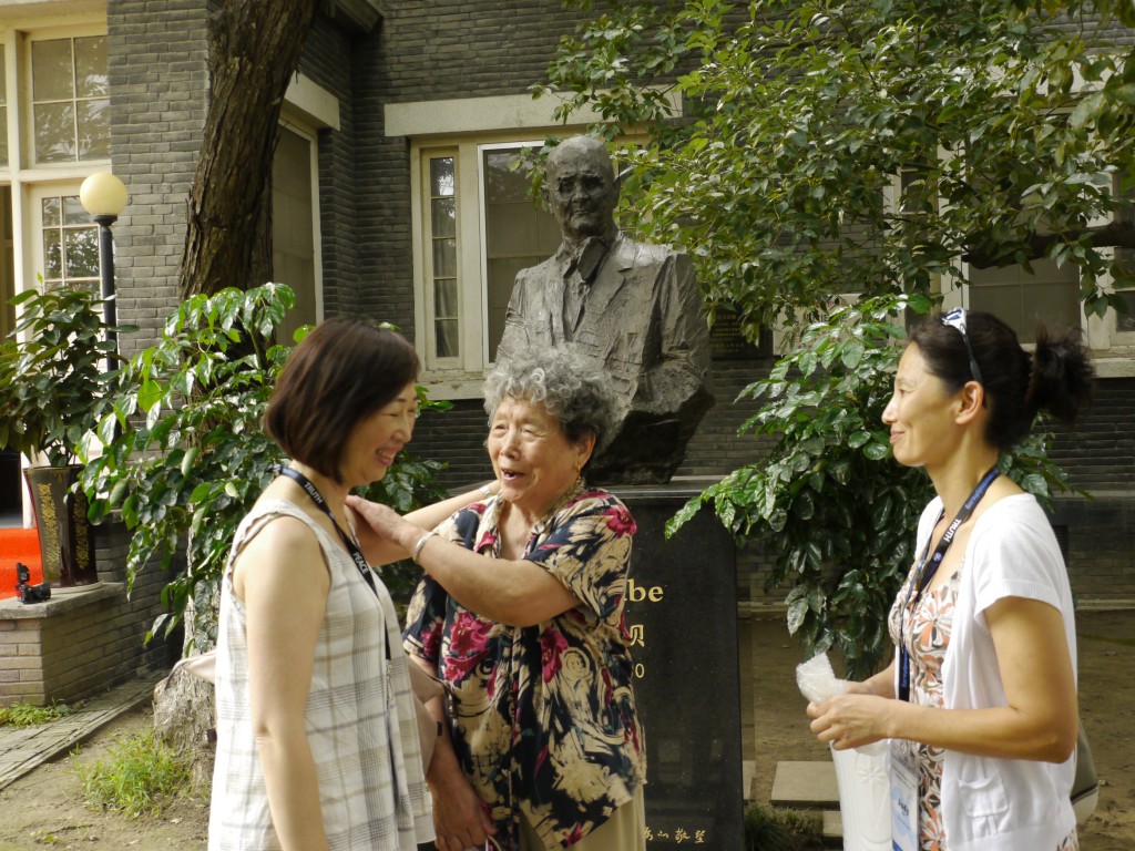 At the John Rabe House study tour leader FLora Chong and Judy Cho greet Nanjing Massacre survivor Ding Zheng Lan who was sheltered in the Safety Zone created by Rabe and several other westerners who remained in Nanjing during the massacre in 1937.